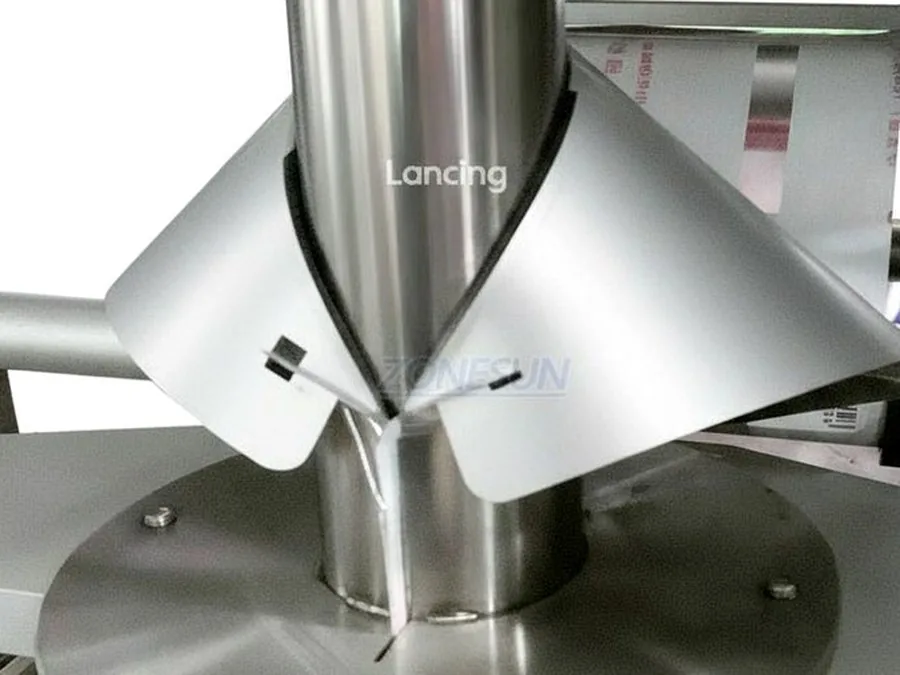 Close-up stainless auger dosing chute used for powder filling projects