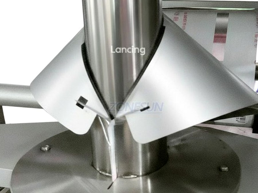 Close-up stainless auger dosing chute used for powder filling projects